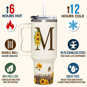 SUFAVN monogrammed tumbler held in hand emphasizes portability and spill resistance
