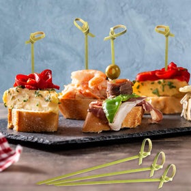 Sugormek picks serving olives and fruits on a platter