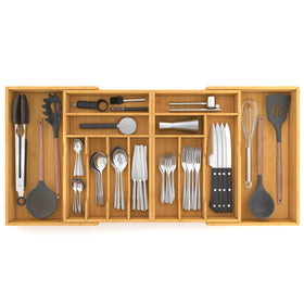 Suli bamboo drawer organizer extended in a wide drawer keeping utensils neatly separated
