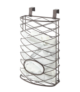 SunnyPoint over-cabinet basket hanging on a brown cabinet door stores up to 50 bags neatly.