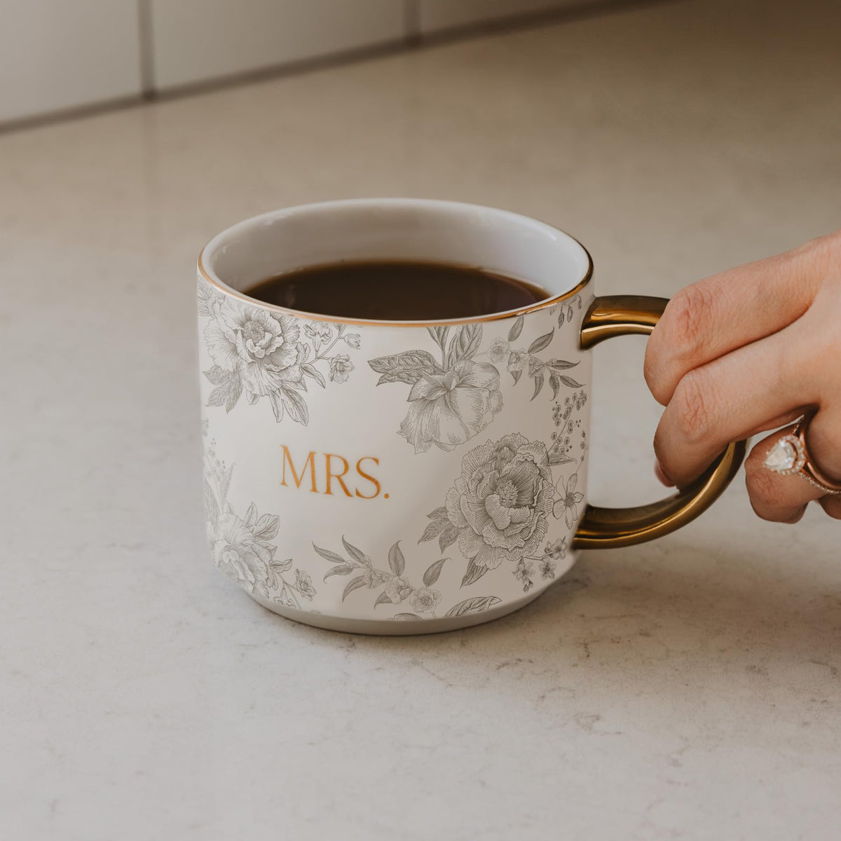 Sweet Water Decor Mrs Mug with gold handle adds elegant touch to morning coffee rituals.