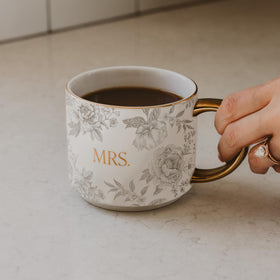 Sweet Water Decor Mrs Mug with gold handle adds elegant touch to morning coffee rituals.