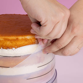 Sweetshop Frost Form stand keeps the cake steady during decorating.