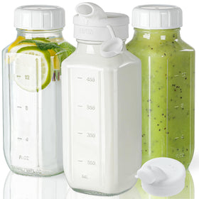 Syntic clear glass juice bottles with lids for travel and storage.