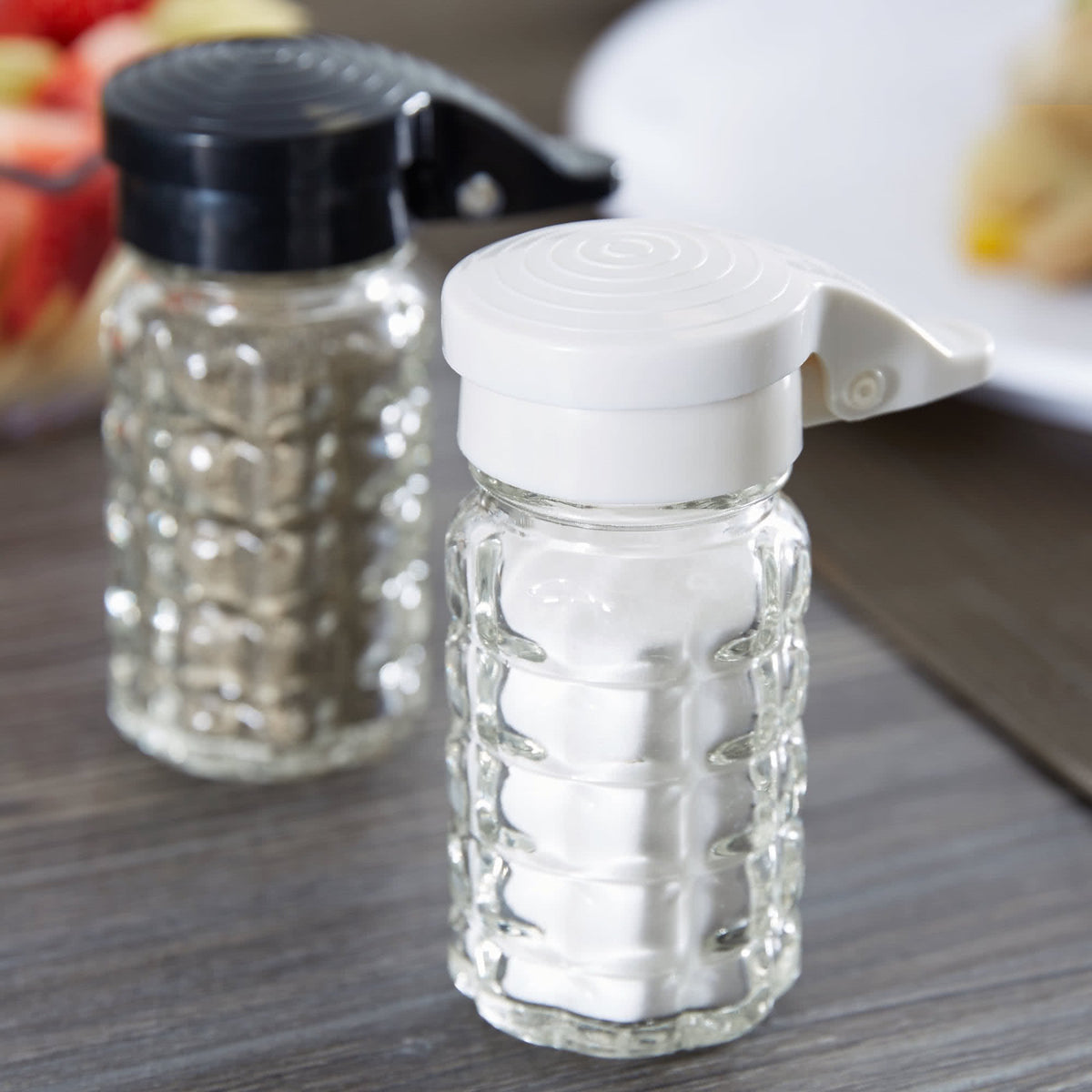 Tablecraft shaker with spring-loaded hinged lid for one-handed use.