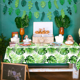 Tatuo tropical party setup with palm leaf decor for luau vibes.