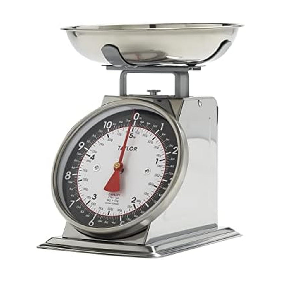 Taylor mechanical scale with removable bowl on a kitchen counter for precise ingredients.