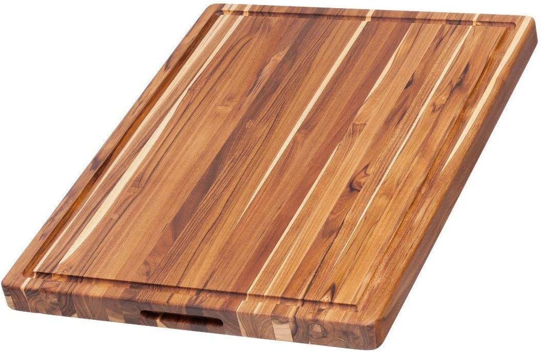 Teakhaus large cutting board with juice groove for mess-free carving and serving.