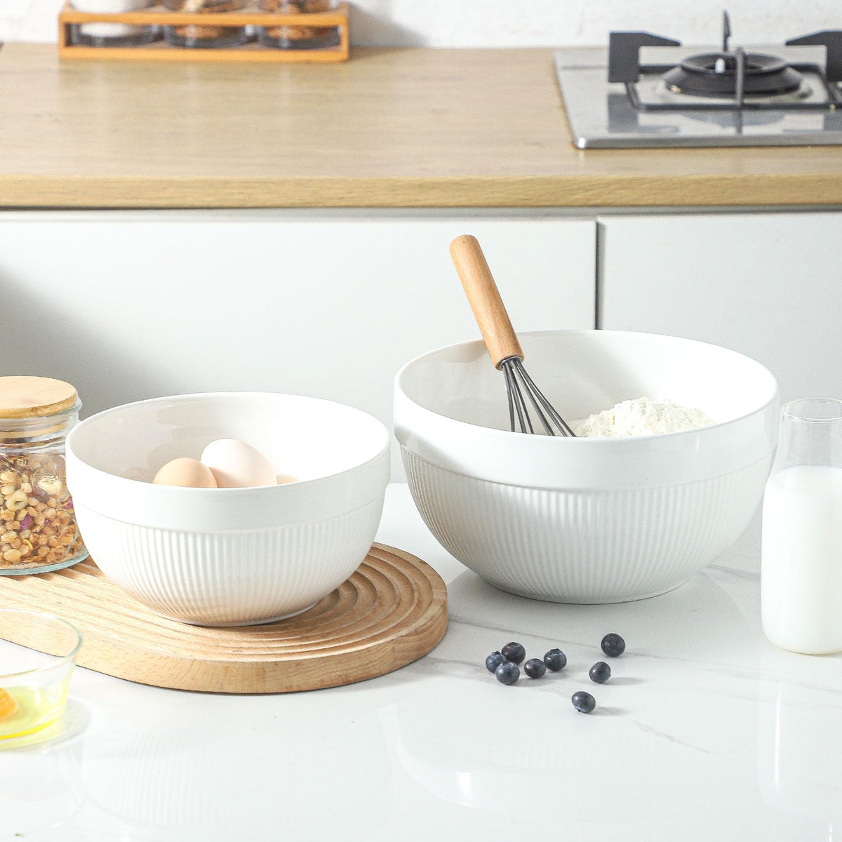 TEAKISS nesting design bowls stored neatly in a kitchen cabinet.