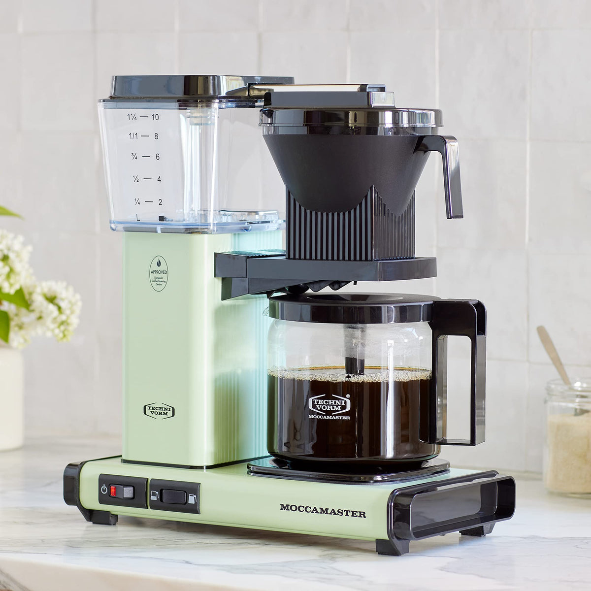 Technivorm Moccamaster KBGV Select pistachio-green kitchen setup with color and reliability.
