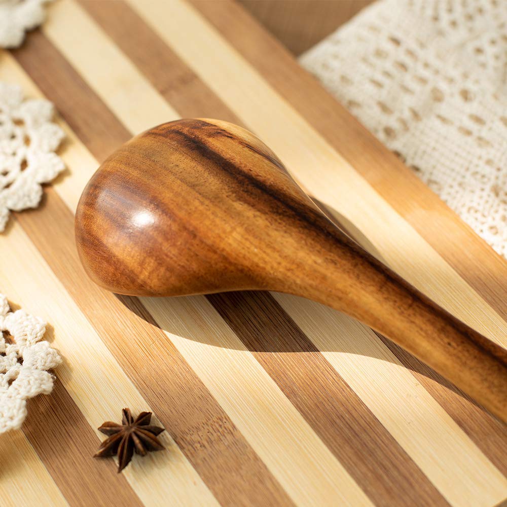TEZZ natural acacia utensils against light kitchen background.