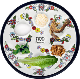 The Dreidel Company Seder plate with blue floral pattern highlighting six ritual indentations.