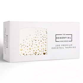 The Essential Concierge gold bar napkins on a stylish table for a glamorous party.