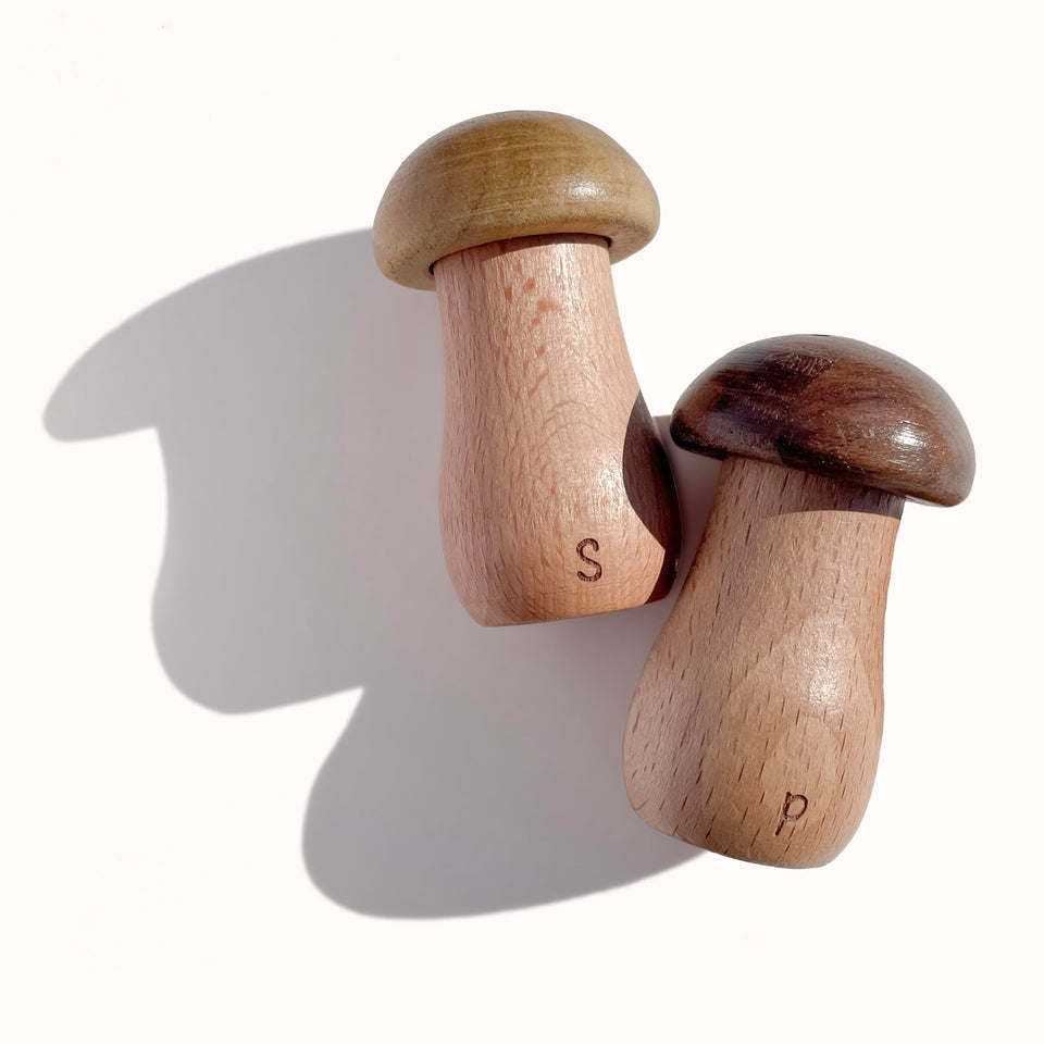 The Loquat Tree mushroom salt and pepper shaker set on a dining table for everyday meals.