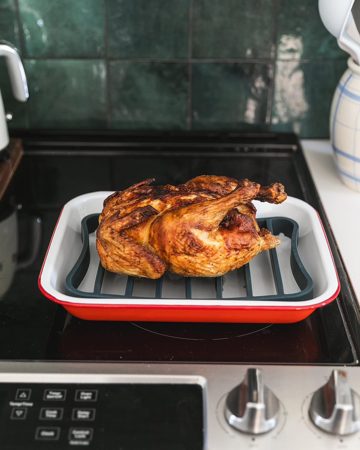 The Silicone Kitchen navy roasting rack on a baking sheet enhances fat drainage.