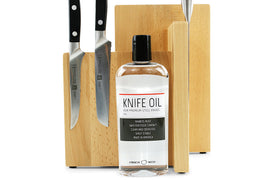 Thirteen Chefs honing oil bottle beside knives ready for storage.