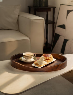 Tidita oval tray shown near sofa for breakfast-in-bed setups.