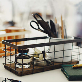 TIEYIPIN wall-mountable metal basket keeps bathroom toiletries within reach.