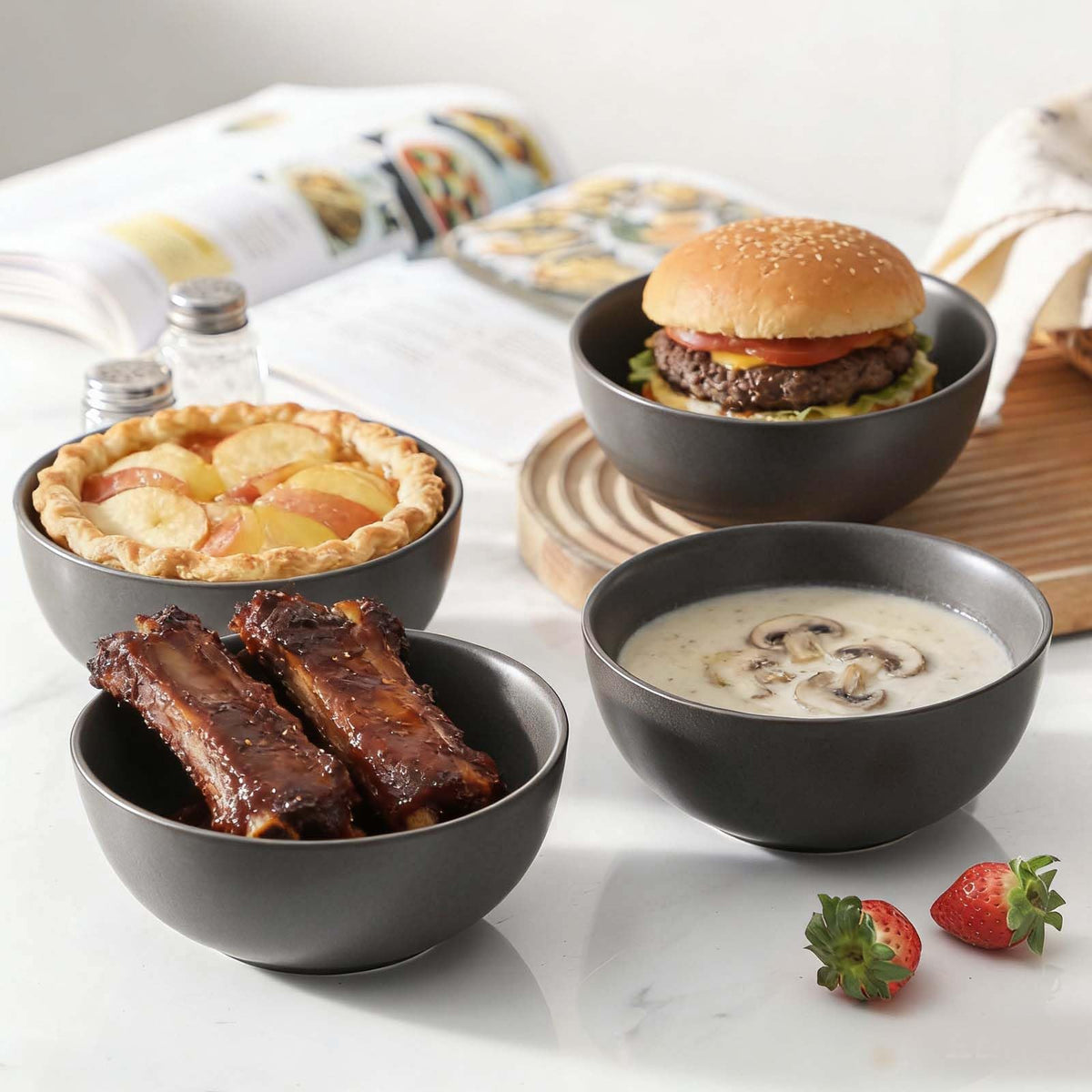 Tikooere set of four dishes in stack view for space-saving storage.