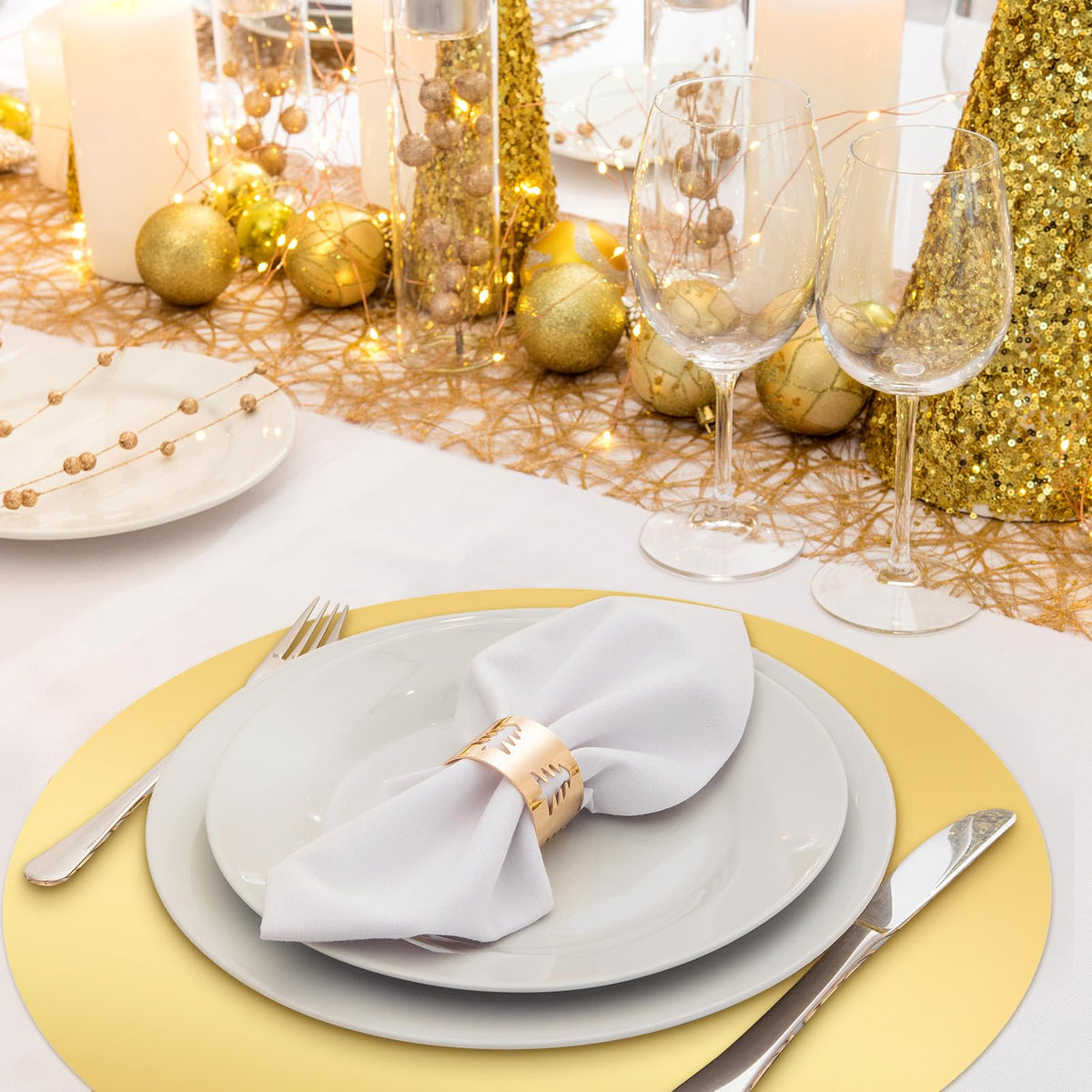 Tioncy placemats on dining table, close-up, elegant gold finish enhances ambiance.