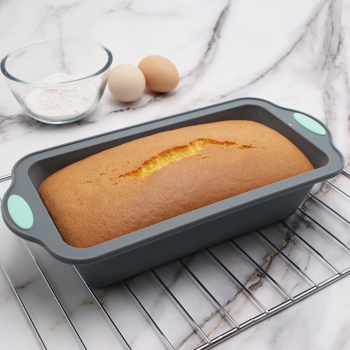 To encounter 9 inch silicone bread pan with metal reinforced edge, side view.
