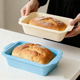 Toeusog nonstick silicone bread pan in beige and mint with metal frame for easy release.