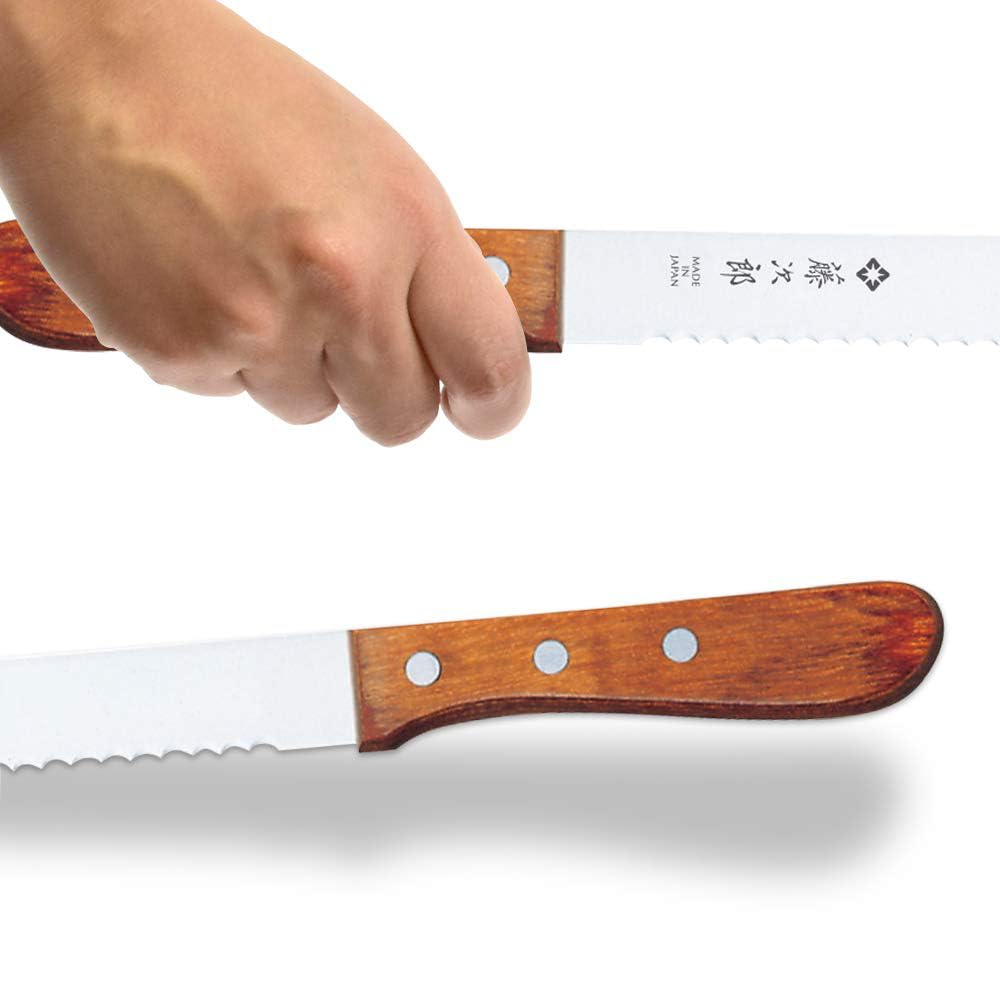 Tojiro bread knife in action slicing a crusty loaf with even slices