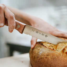 Tojiro natural wood handle close-up emphasizing comfortable grip and balance