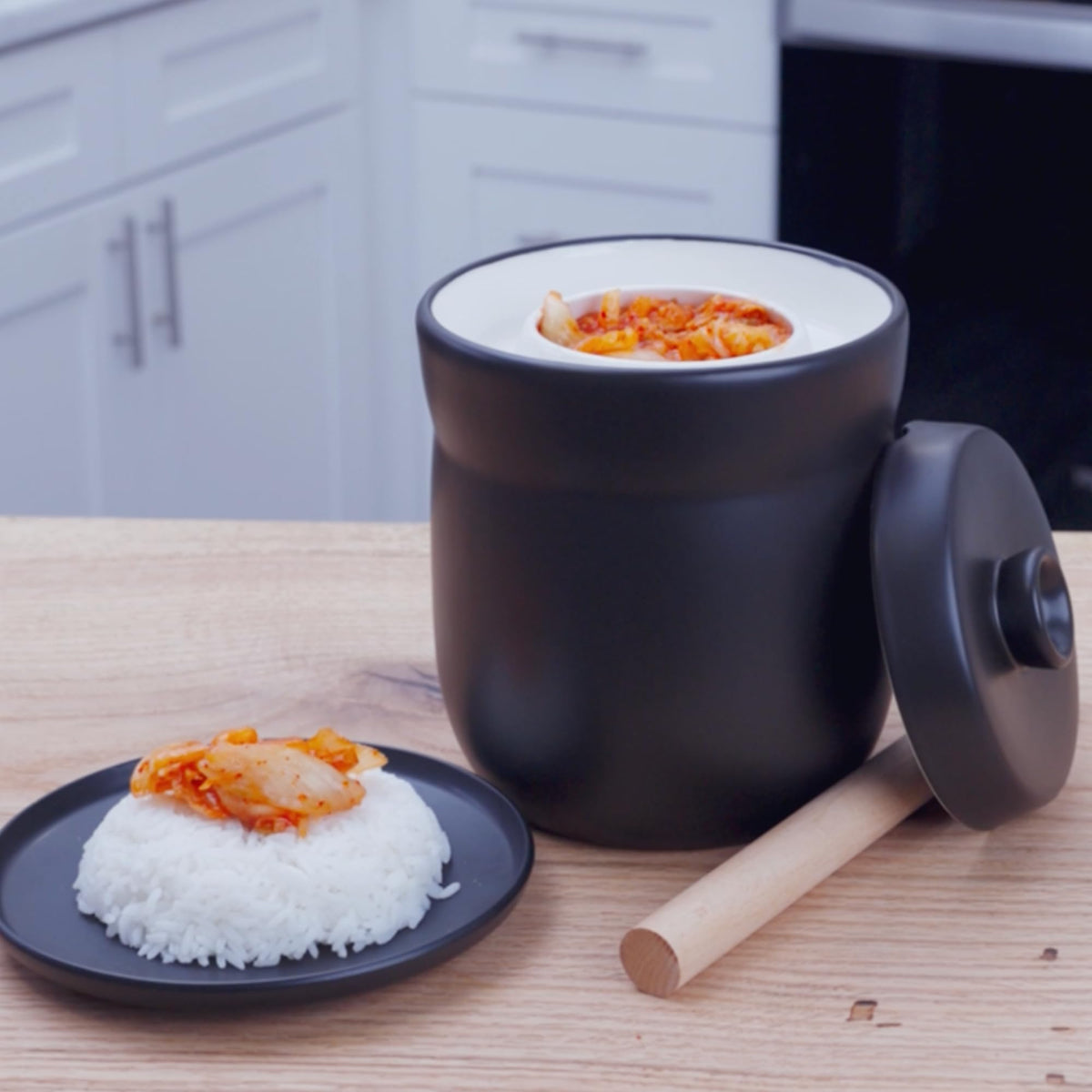 TOMO fermentation crock shown in kitchen setup ready for pickles or kimchi