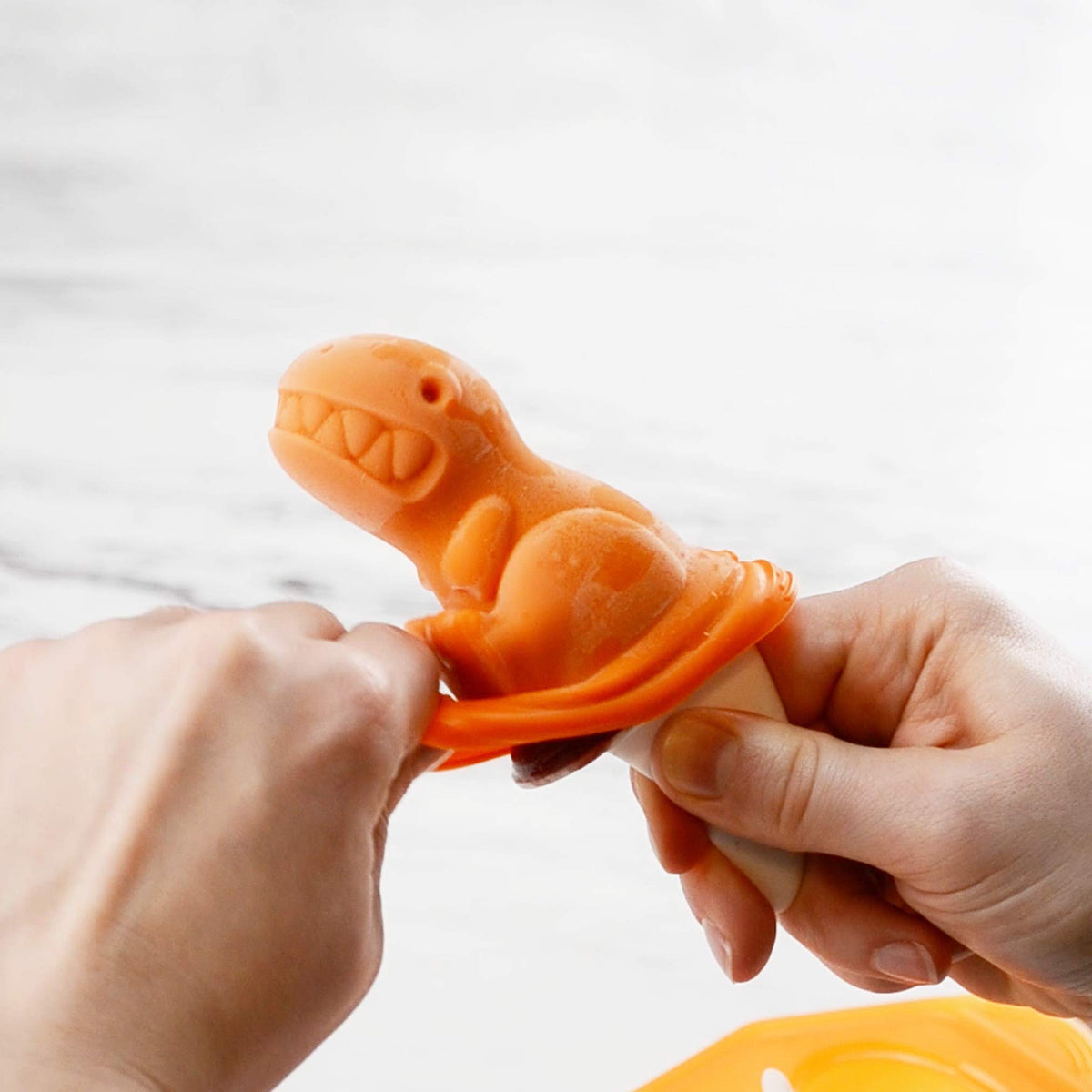 Tovolo fossil bone handles offer easy grip for kids during pops.