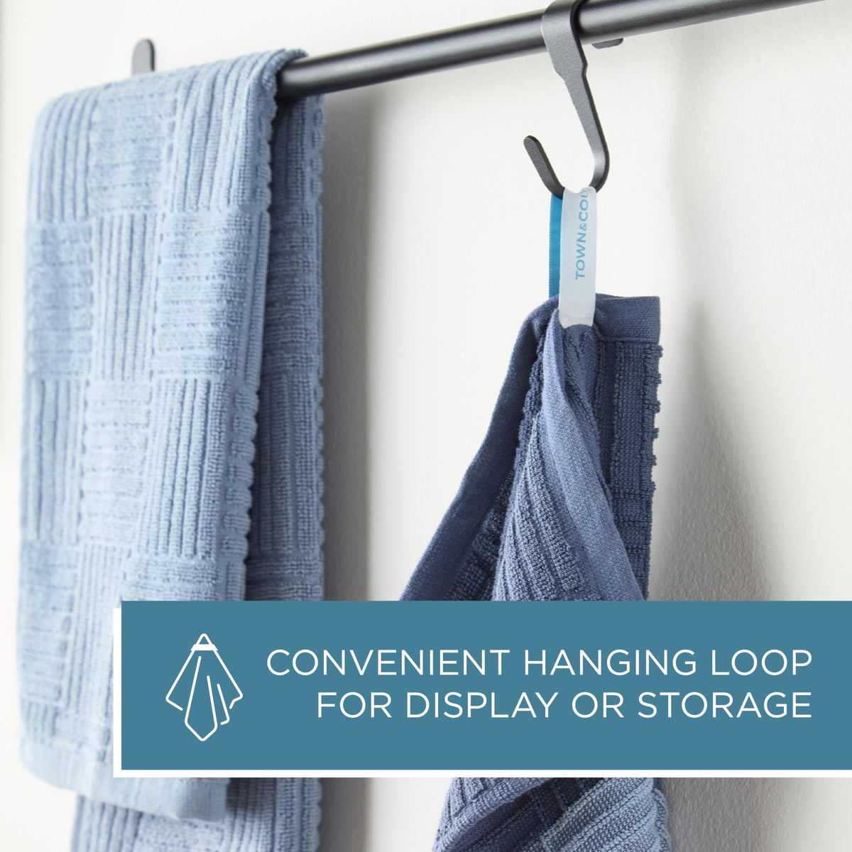 Town & Country Basics basketweave towel blue in use for wiping a spill in the kitchen.