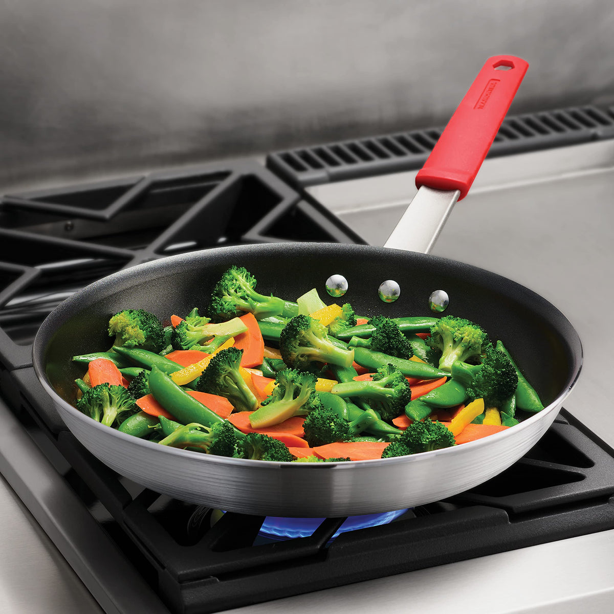 Tramontina Professional heavy-gauge aluminum ensures consistent heat.