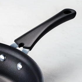 Tramontina teal reinforced nonstick surface close-up for smooth release