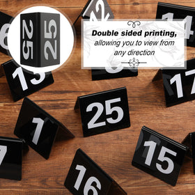 Tuanse table numbers with bold white digits on black acrylic for high contrast.