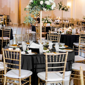 TUOTPE wedding and banquet setup using black round tablecloths for a classy tablescape.