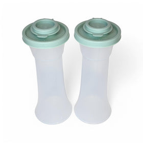 Tupperware large hourglass salt and pepper shakers in clear glass with sage green seal for fresher flavor.