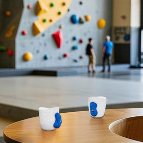 Two Stones white and blue mug fits climber desk or kitchen setups.