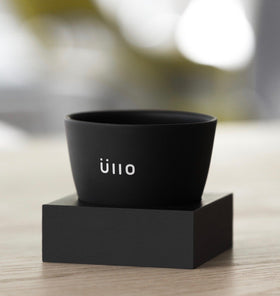 Üllo rest-on-glass depicts purifier resting on a wine glass for easy purification.