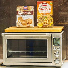 Umilife cutting board on oven with stored mitts and liners for extra surface