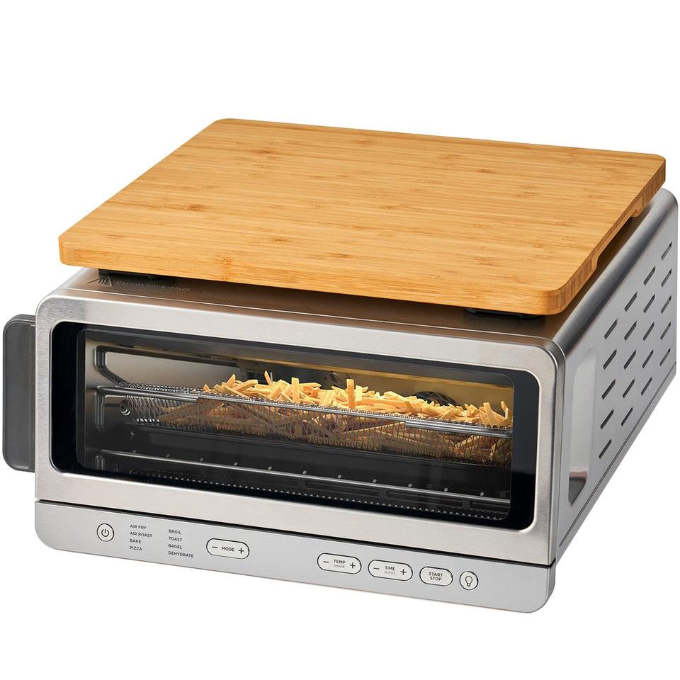 Umilife cutting board atop the oven showing extra storage and heat protection