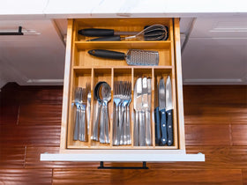 Umilife silverware drawer caddy keeps forks spoons and knives neatly arranged.
