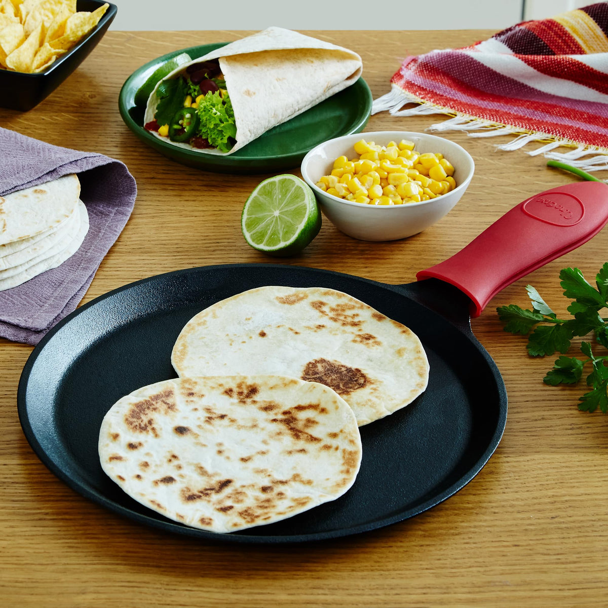 Uno Casa comal cooking tortillas and pancakes on the surface.