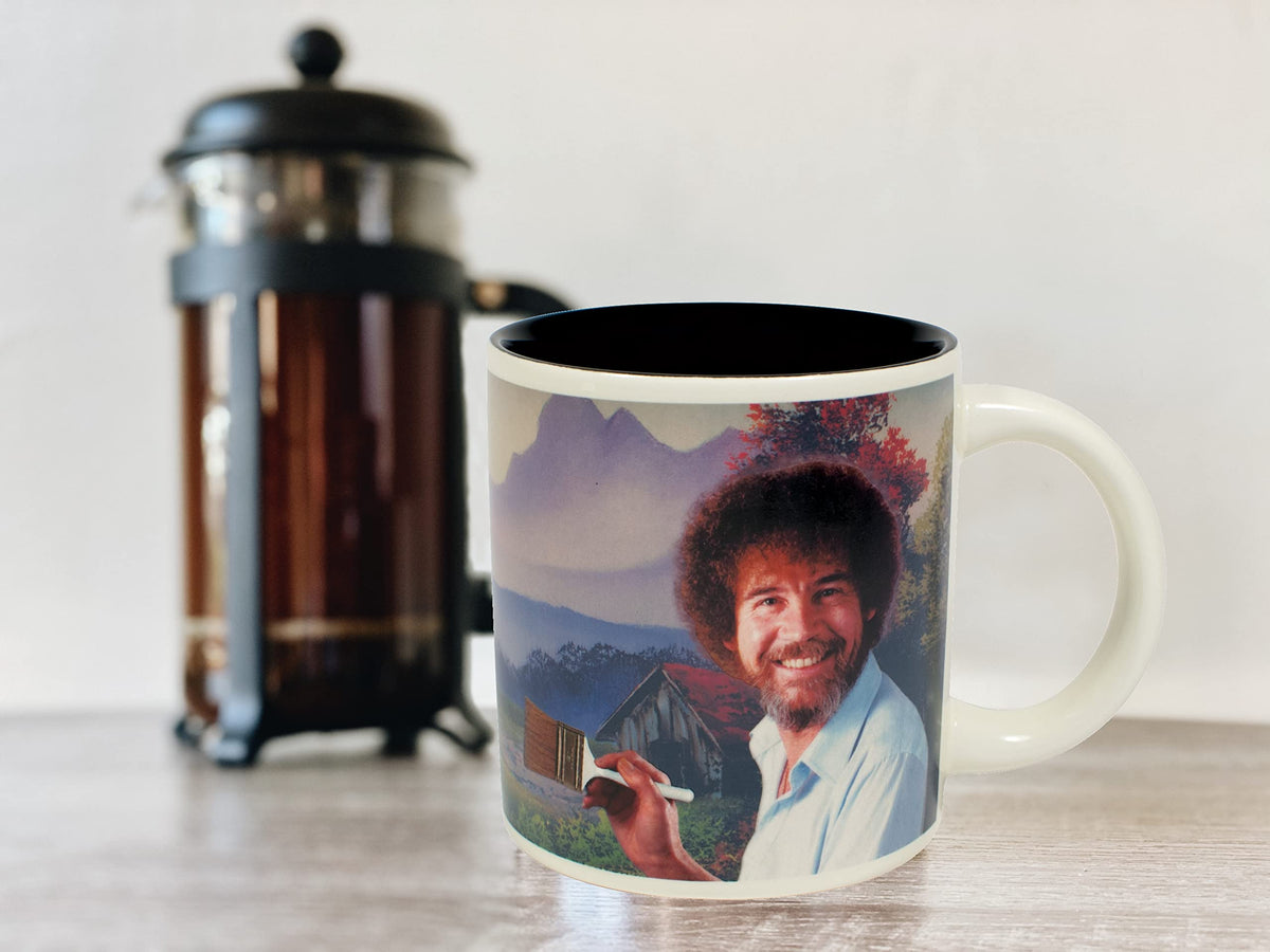 Gift-ready box featuring the Bob Ross heat-changing mug design.
