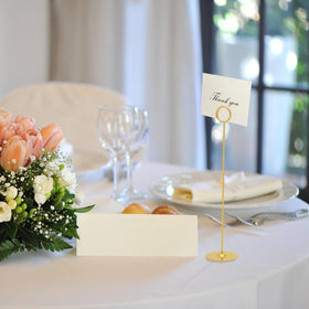 Urban Deco gold holder displaying a food sign at a reception