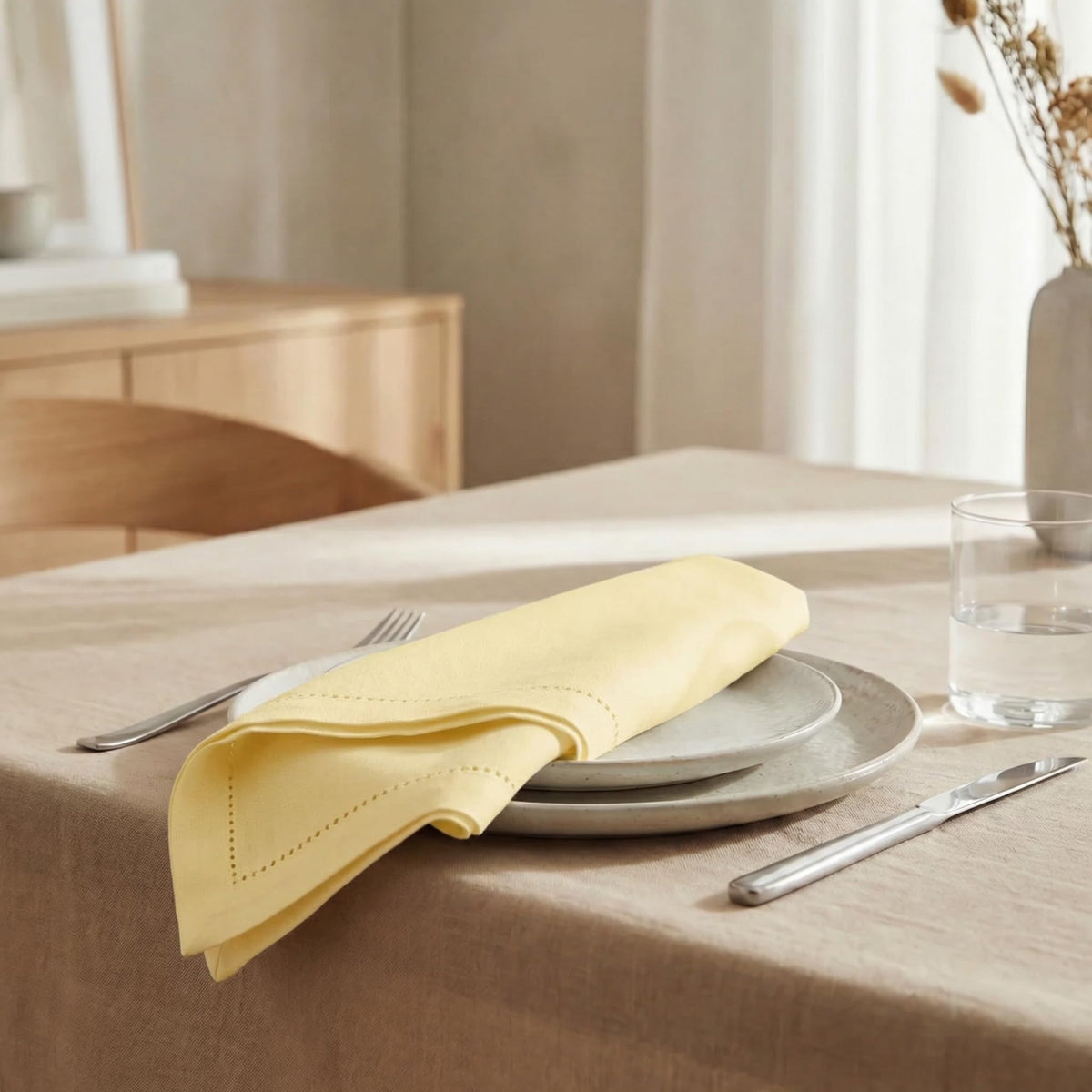 Urban Villa yellow hemstitch napkins on a dining table elevate dinner ambiance
