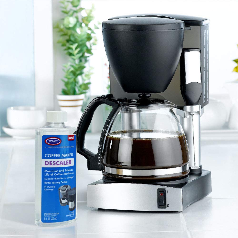 Urnex bottle beside coffee beans communicates home-use maintenance.
