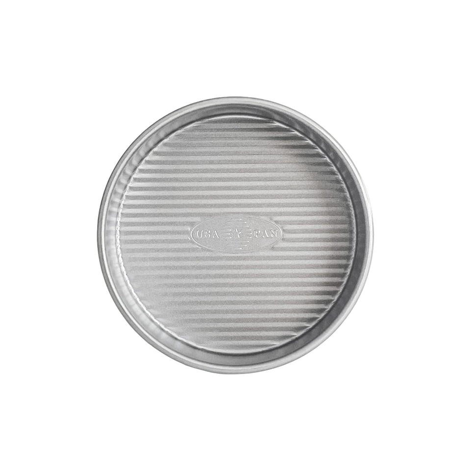 USA Pan 6-Inch Round Cake Pan top view highlighting Americoat Plus II nonstick coating for easy release.