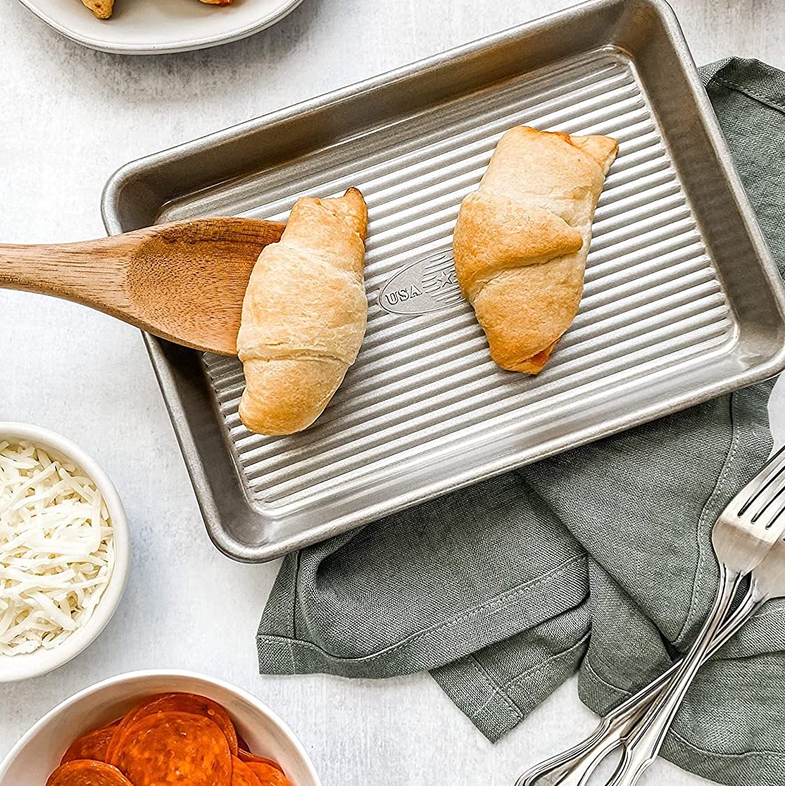Reinforced rim of USA Pan mini sheet pan enhances strength and warp resistance.