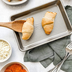 Reinforced rim of USA Pan mini sheet pan enhances strength and warp resistance.