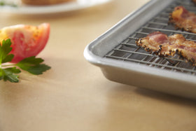 USA Pan XL cooling rack with six raised feet for improved airflow and cooling.
